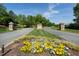 Picturesque entrance to Legacy community with manicured landscaping, mature trees, and elegant stone signage at 213 North Crest Dr, Chapel Hill, NC 27517