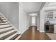 Inviting foyer with hardwood floors, staircase, and a clear view to the front door and stylish built-in bar at 213 North Crest Dr, Chapel Hill, NC 27517