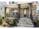Charming front porch with stone detailing, wrought-iron railings and a well-manicured garden, providing a warm entrance at 213 North Crest Dr, Chapel Hill, NC 27517