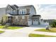 Side view of a two-story home with a two-car garage and extended driveway, surrounded by green grass at 213 North Crest Dr, Chapel Hill, NC 27517