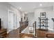 Open hallway with wood floors and stairs leading to the loft area with a decorative display shelf at 213 North Crest Dr, Chapel Hill, NC 27517