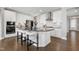 Stylish kitchen features an island with bar seating, stainless steel appliances and white cabinetry at 213 North Crest Dr, Chapel Hill, NC 27517