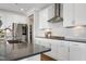 Modern kitchen showcasing stainless steel appliances, white cabinetry, and stone countertops at 213 North Crest Dr, Chapel Hill, NC 27517