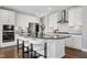 Elegant kitchen featuring stainless appliances, a large island and sleek white cabinets at 213 North Crest Dr, Chapel Hill, NC 27517