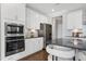 Gorgeous kitchen features stainless appliances, white cabinetry, and stone countertops at 213 North Crest Dr, Chapel Hill, NC 27517