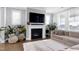 Warm living room showcasing a stylish fireplace, large TV, and comfortable seating for relaxing at home at 213 North Crest Dr, Chapel Hill, NC 27517