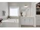 Soaking tub with separate sink vanities and walk-in closet access for added convenience at 213 North Crest Dr, Chapel Hill, NC 27517
