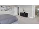 This spacious main bedroom has a black dresser, grey carpet, and ensuite bathroom at 213 North Crest Dr, Chapel Hill, NC 27517