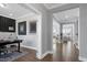 Bright home office with gray walls, hardwood floors, modern art, and a view into the living room at 213 North Crest Dr, Chapel Hill, NC 27517