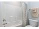 Shower with a white surround and chrome fixtures and a shower curtain with neutral colored stripes at 213 North Crest Dr, Chapel Hill, NC 27517
