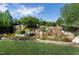 Scenic waterfall cascading over rocks into a pond, surrounded by lush greenery in the Legacy community at 213 North Crest Dr, Chapel Hill, NC 27517