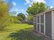 View of spacious backyard with well-maintained lawn, storage shed, and mature trees at 215 Haywood St, Raleigh, NC 27601