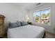 Bedroom features large window for natural light, neutral walls, and a table with lamp on either side of bed at 215 Haywood St, Raleigh, NC 27601