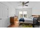 Bright bedroom with wood floors, white walls, ceiling fan, and a large window that provides natural light at 215 Haywood St, Raleigh, NC 27601