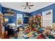 Bright bedroom with a ceiling fan, large windows, built-in shelving and colorful rug providing a comfortable retreat at 215 Haywood St, Raleigh, NC 27601