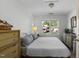 Bedroom features large window for natural light, neutral walls, ceiling light and dressers on either side of bed at 215 Haywood St, Raleigh, NC 27601