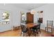 Dining room featuring wood floors, a large dining table, and plenty of natural light at 215 Haywood St, Raleigh, NC 27601