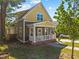 Exterior view showcasing the home's yellow and gray facade, complemented by a charming front porch at 215 Haywood St, Raleigh, NC 27601