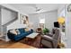 A cozy living room with hardwood floors, a ceiling fan, and bright sunlight at 215 Haywood St, Raleigh, NC 27601