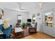Bright living room featuring hardwood floors, a ceiling fan, and ample natural light at 215 Haywood St, Raleigh, NC 27601