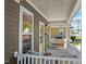 Charming porch with cozy wicker seating, perfect for relaxing and enjoying the neighborhood views at 215 Haywood St, Raleigh, NC 27601