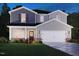 Charming two-story home showcasing classic architectural details and a well-manicured lawn, creating an inviting curb appeal at 2215 Cherry Creek Rd, Haw River, NC 27258