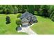 Beautiful home surrounded by lush greenery, featuring a long driveway and well-manicured lawn at 226 Marshview Cir, Angier, NC 27501