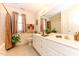 Bright bathroom features a double sink vanity, large mirror, and tub-shower combo with natural light at 226 Marshview Cir, Angier, NC 27501