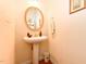 Powder room features a pedestal sink, gold-trimmed mirror, and decorative accessories at 226 Marshview Cir, Angier, NC 27501