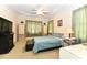 Comfortable bedroom featuring a tray ceiling, ceiling fan, and ample natural light at 226 Marshview Cir, Angier, NC 27501