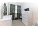 Bright bedroom with mirror, dresser, patterned curtains, and neutral carpet at 226 Marshview Cir, Angier, NC 27501