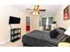 Cozy bedroom features a striped bedspread, mounted tv, and floral curtains at 226 Marshview Cir, Angier, NC 27501