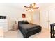 Bedroom features a ceiling fan, patterned bedspread, and neutral colored carpet at 226 Marshview Cir, Angier, NC 27501