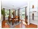 Cozy dining area with wood table and chairs, large windows, and doors to a patio, perfect for casual meals at 226 Marshview Cir, Angier, NC 27501
