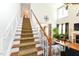 Open foyer featuring staircase leading to a living room with fireplace and many windows at 226 Marshview Cir, Angier, NC 27501