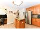 Bright kitchen with a central island, stainless steel refrigerator, and tile flooring at 226 Marshview Cir, Angier, NC 27501