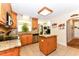 Well-lit kitchen with wooden cabinets, granite countertops, stainless steel appliances, and tile flooring at 226 Marshview Cir, Angier, NC 27501