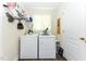 Bright laundry room with front loading washer and dryer, shelving, and natural light at 226 Marshview Cir, Angier, NC 27501