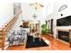 Inviting living room featuring a fireplace, staircase, hardwood floors, and ample natural light at 226 Marshview Cir, Angier, NC 27501