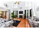 Spacious living room with fireplace, hardwood floors, large windows, and a cozy seating area at 226 Marshview Cir, Angier, NC 27501