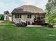 Spacious backyard with patio, firepit, and outdoor dining area perfect for entertaining at 2317 Emerald Woods Dr, Wake Forest, NC 27587
