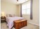 Comfortable bedroom with neutral carpet, purple bedding, side table, and wooden chest at 2317 Emerald Woods Dr, Wake Forest, NC 27587
