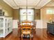 Traditional dining room with hardwood floors, large window, and neutral tones at 2317 Emerald Woods Dr, Wake Forest, NC 27587