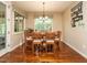 Casual dining room with large windows, wood floors, and seating for seven at 2317 Emerald Woods Dr, Wake Forest, NC 27587