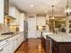 Open kitchen design with stainless appliances, farm sink, granite counters, and access to living spaces at 2317 Emerald Woods Dr, Wake Forest, NC 27587