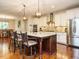 Spacious kitchen island with granite countertops, stainless steel appliances, and pendant lighting at 2317 Emerald Woods Dr, Wake Forest, NC 27587