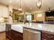 Large island with a farm sink, granite countertop and view of the living room at 2317 Emerald Woods Dr, Wake Forest, NC 27587