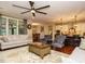 Open-concept living area with hardwood floors seamlessly connecting to the kitchen and dining area at 2317 Emerald Woods Dr, Wake Forest, NC 27587