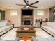 Inviting living room with fireplace, ceiling fan, natural light, and hardwood floors at 2317 Emerald Woods Dr, Wake Forest, NC 27587