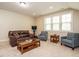 Bright living room with large windows, comfortable seating, and a center coffee table at 2317 Emerald Woods Dr, Wake Forest, NC 27587
